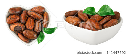 cocoa beans in ceramic bowl isolated on white background. Top view. Flat lay cocoa beans in ceramic bowl isolated on white background. Top view. Flat lay 141447392