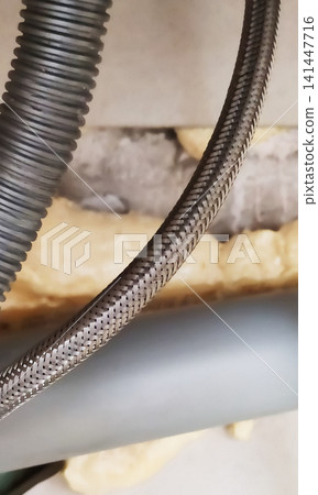 Flexible hose with a metal braided sheath. Flexible hose with a metal braided sheath. 141447716