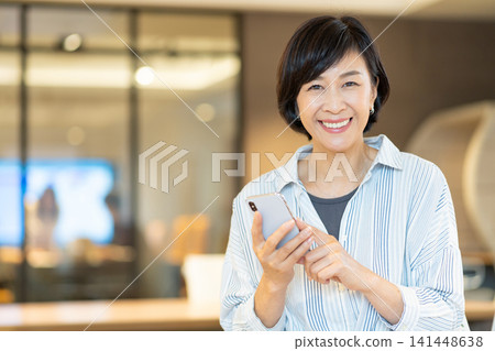 Senior woman operating a smartphone Senior woman operating a smartphone 141448638