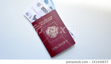 Russian citizen passport and invested rubles on a white background Russian citizen passport and invested rubles on a white background 141448657