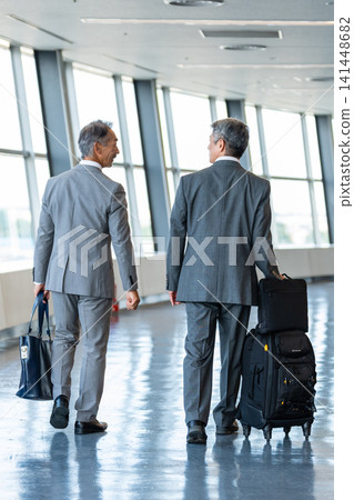 A businessman walking in the airport A businessman walking in the airport 141448682