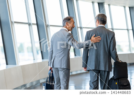 A businessman walking in the airport A businessman walking in the airport 141448683