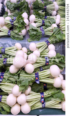 Harvested white turnips lined up at the greengrocer Harvested white turnips lined up at the greengrocer 141448704