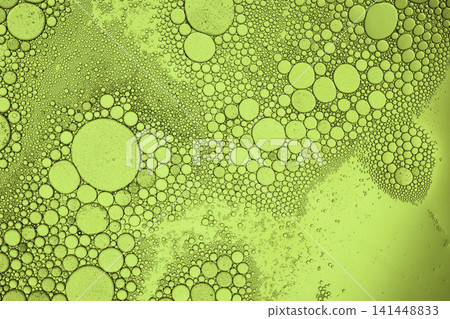 Oil drops and tiny water bubbles form an abstract texture in green liquid Oil drops and tiny water bubbles form an abstract texture in green liquid 141448833
