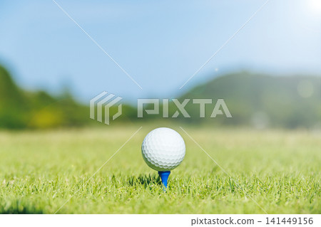 A teed-up golf ball and the teeing ground A teed-up golf ball and the teeing ground 141449156