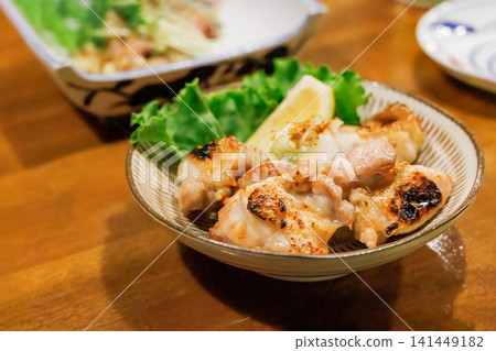 A classic izakaya menu item: charcoal-grilled local chicken, cooked to perfection. A classic izakaya menu item: charcoal-grilled local chicken, cooked to perfection. 141449182