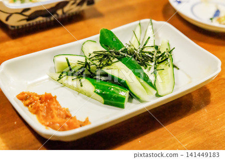 Fresh morokyu (cucumber) served with miso and shredded nori seaweed. Fresh morokyu (cucumber) served with miso and shredded nori seaweed. 141449183
