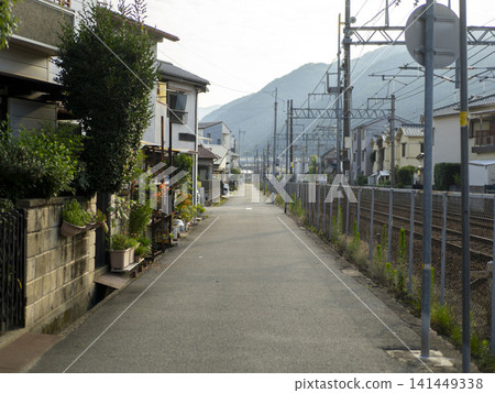 A residential road running parallel to the railway tracks. A residential road running parallel to the railway tracks. 141449338
