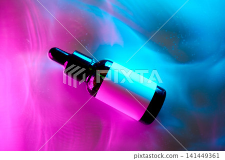 Skincare serum dropper bottle in neon light Skincare serum dropper bottle in neon light 141449361