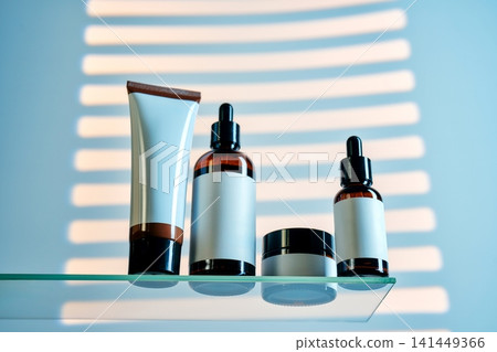 Cosmetics and serum bottles on glass shelf with light stripes Cosmetics and serum bottles on glass shelf with light stripes 141449366