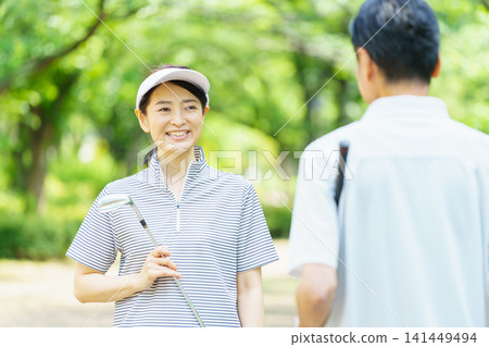 Senior couple with golf clubs Senior couple with golf clubs 141449494