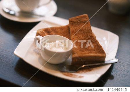 Cinnamon toast eaten at a coffee shop Cinnamon toast eaten at a coffee shop 141449545