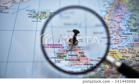 Magnifying glass highlighting BELFAST on paper map Magnifying glass highlighting BELFAST on paper map 141449898