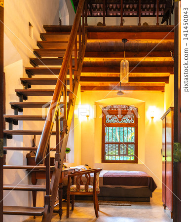 Cozy loft bedroom with wooden staircase and warm ambient lighting Cozy loft bedroom with wooden staircase and warm ambient lighting 141450043