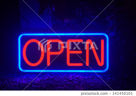 Open neon sign glowing in blue and red light for a retail storefront or business entrance Open neon sign glowing in blue and red light for a retail storefront or business entrance 141450101