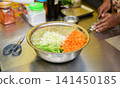 Fresh vegetable salad ingredients being prepared in a professional kitchen 141450185