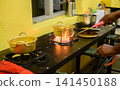 Korean ramen cooking in a pot on a gas stove in a restaurant kitchen 141450188