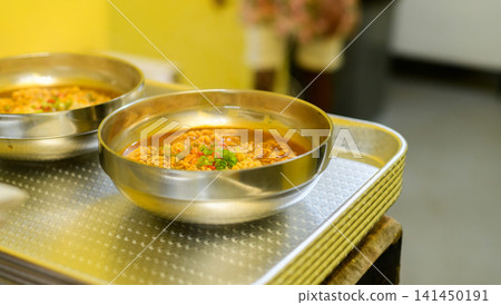 Two spicy ramen noodle soups with egg, ready to be served on a metal plate Two spicy ramen noodle soups with egg, ready to be served on a metal plate 141450191