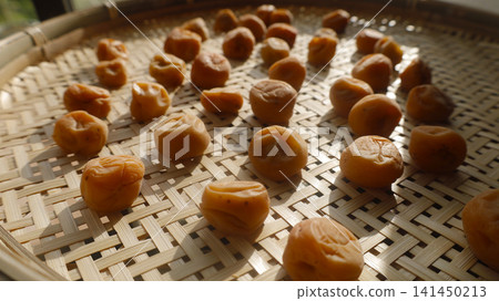 Traditional homemade white pickled plums: A scene of them being dried in the summer sun. Traditional homemade white pickled plums: A scene of them being dried in the summer sun. 141450213