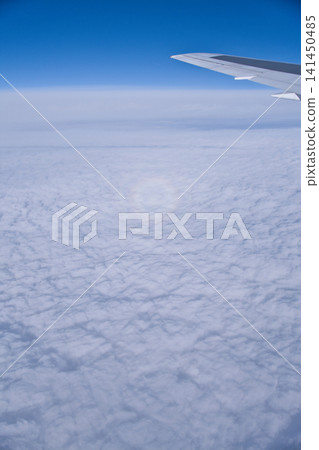 A rainbow visible from an airplane A rainbow visible from an airplane 141450485