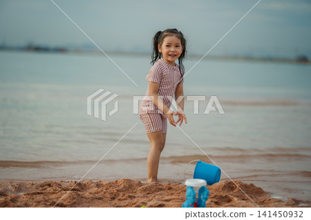 happy preschool child girl playing on sea beach in Pattaya, Thailand happy preschool child girl playing on sea beach in Pattaya, Thailand 141450932