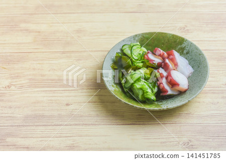 Cucumber and octopus salad with vinegar dressing Cucumber and octopus salad with vinegar dressing 141451785