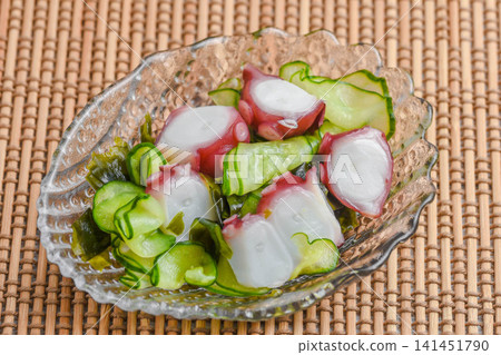 Cucumber and octopus salad with vinegar dressing Cucumber and octopus salad with vinegar dressing 141451790