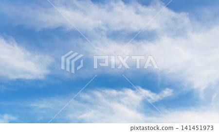 A photograph of a blue sky and clouds on an early summer day. A photograph of a blue sky and clouds on an early summer day. 141451973