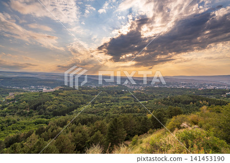 View of the mountains and Kislovodsk from the observation decks of the Kislovodsk Park. Evening sunset over the mountains of Kislovodsk. View of the mountains and Kislovodsk from the observation decks of the Kislovodsk Park. Evening sunset over the mountains of Kislovodsk. 141453190