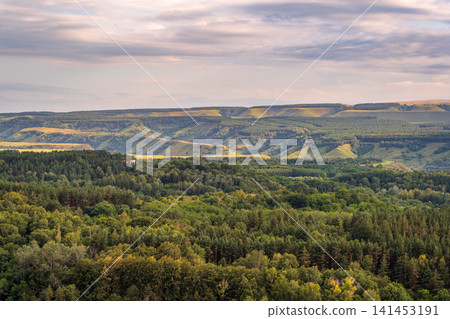 Layers of green mountains and hills in the haze during sunset. Panoramic View of Green hills and Meadow. Layers of green mountains and hills in the haze during sunset. Panoramic View of Green hills and Meadow. 141453191