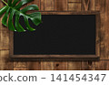 Blackboard with shelves, adorned with monstera leaves, made of dark oak. 141454347