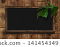 Blackboard with shelves, adorned with monstera leaves, made of dark oak. 141454349