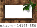 A dark oak whiteboard with shelves, adorned with monstera leaves. 141454350