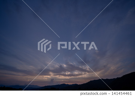 The twilight sky is filled with radially spreading clouds. The twilight sky is filled with radially spreading clouds. 141454461