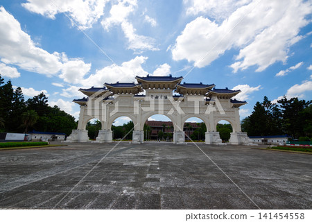 The archway of Liberty Square in Taiwan, set against a backdrop of blue sky and clouds. The archway of Liberty Square in Taiwan, set against a backdrop of blue sky and clouds. 141454558