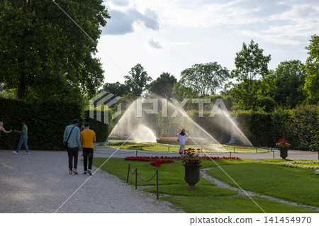 Vienna, Austria - June 15, 2023: Watering lawns in the Schoenbrunn Palace Park Vienna, Austria - June 15, 2023: Watering lawns in the Schoenbrunn Palace Park 141454970