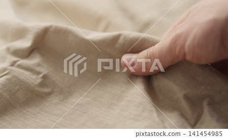 man hand checking natural cotton jersey cloth man hand checking natural cotton jersey cloth 141454985