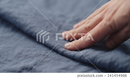 man hand checking blue linen shirt cloth man hand checking blue linen shirt cloth 141454986