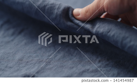 man hand checking blue linen shirt cloth man hand checking blue linen shirt cloth 141454987