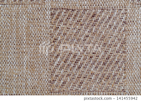 High angle view of a rectangular canvas sample patch on a woven beige textile background High angle view of a rectangular canvas sample patch on a woven beige textile background 141455942