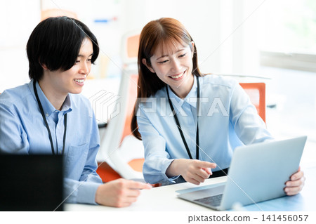 Men and women talking in the office Men and women talking in the office 141456057