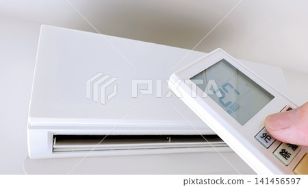 Adjust the air conditioner temperature with the remote control. Adjust the air conditioner temperature with the remote control. 141456597