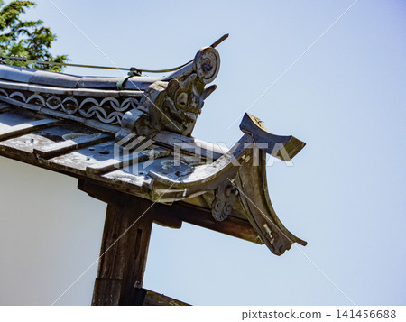Decorative roof tiles on the udatsu (decorative roof finial) of the former Ota Wakihonjin Hayashi family residence in Ota-juku on the Nakasendo road. Decorative roof tiles on the udatsu (decorative roof finial) of the former Ota Wakihonjin Hayashi family residence in Ota-juku on the Nakasendo road. 141456688