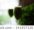 Fresh organic kale smoothie with kale leaves in background. 141457126