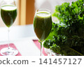 Fresh organic kale smoothie with kale leaves in background. 141457127