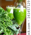 Fresh organic kale smoothie with kale leaves in background. 141457129