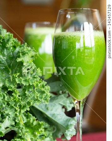 Fresh organic kale smoothie with kale leaves in background. 141457129
