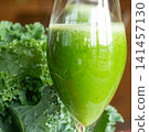 Fresh organic kale smoothie with kale leaves in background. 141457130