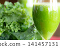 Fresh organic kale smoothie with kale leaves in background. 141457131