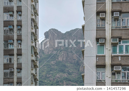 Hong Kong. July 19 2026 Lion Rock peak framed between highrise apartment buildings. 141457296